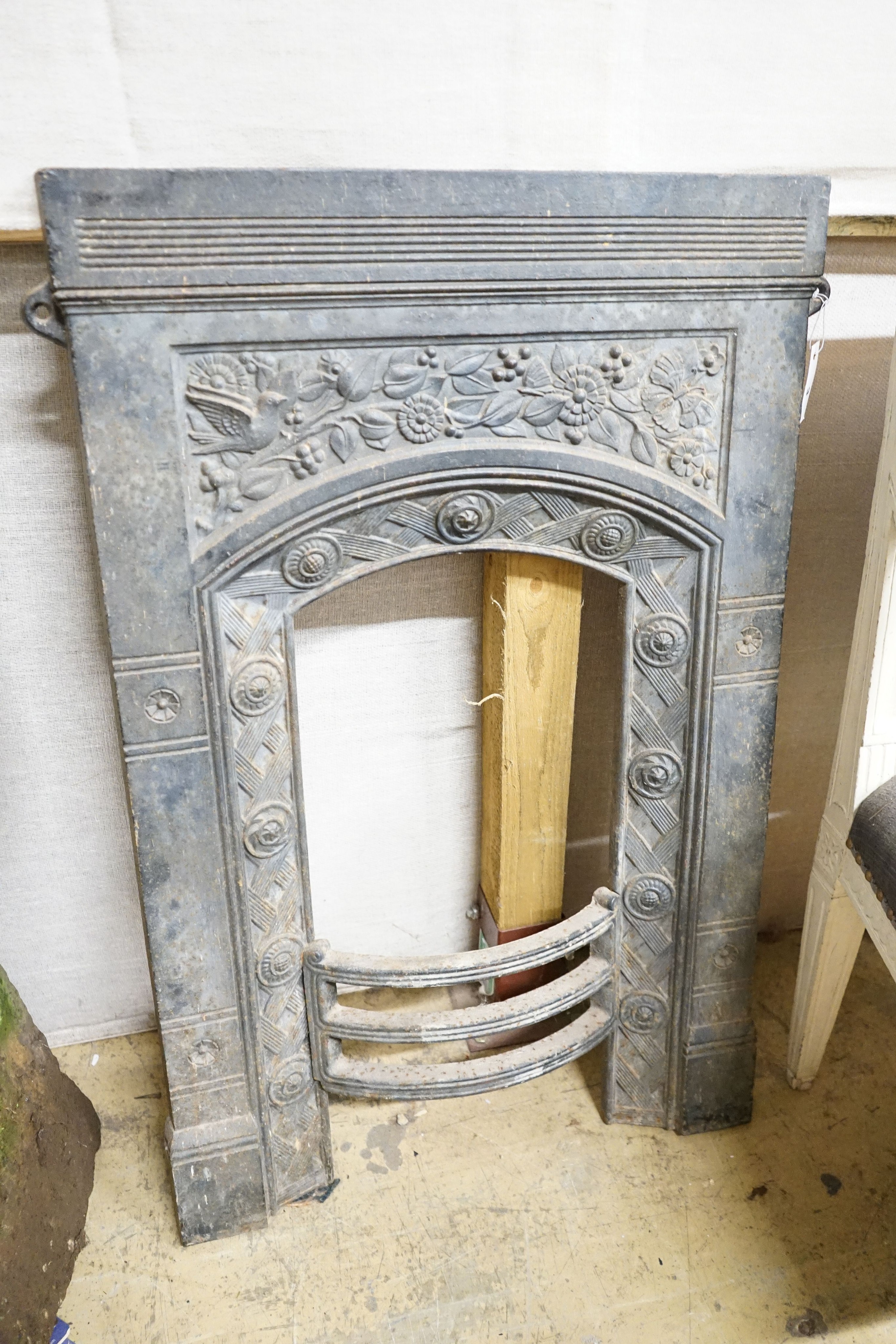 A Victorian cast iron fire insert, Thomas Jekyll, width 62cm, height 94cm